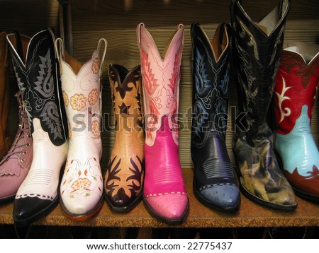 Row of colorful boots on shelf.