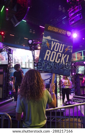 E3; The Electronic Entertainment Expo at the Los Angeles Convention Center, June 16, 2015. Los Angeles, California. The Guitar Hero demo allowed players to become rock stars complete with groupies.