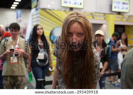 July 9, 2015: San Diego Comic Con, the annual pop culture and fandom convention in San Diego, California. A Zombie at the Walking Dead booth.