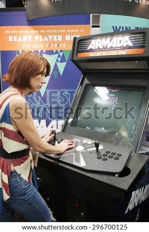 July 10, 2015: San Diego Comic Con, the annual pop culture and fandom convention in San Diego, California. TV Web Series host Meredith Placko plays a demo of a video game at the Ready Player One booth
