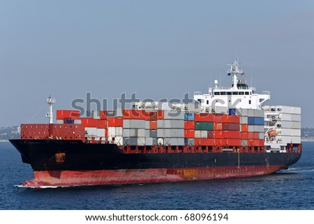 Container cargo ship sailing on the ocean.