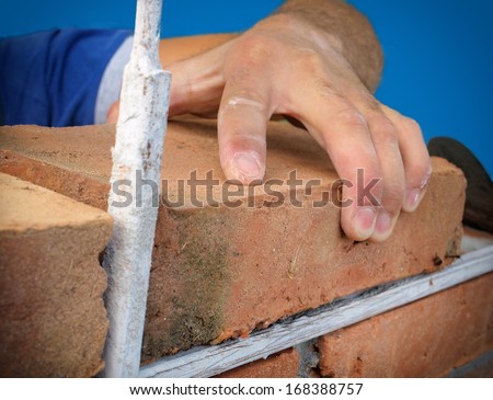 Close-up of construction process mason work with brick installation