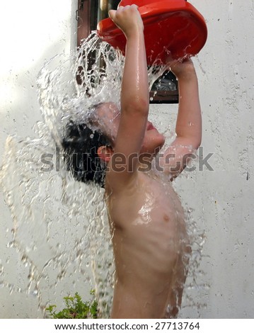 five-year boy enjoys playing with water