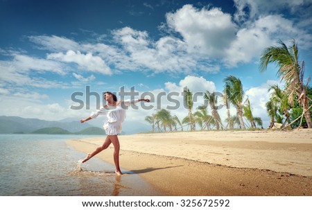 Girl model is located on the beautiful tropical coast. Rest, relaxation, travel.