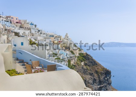 Picturesque architecture of  greek houses in Fira town above the beautiful blue bay at Santorini (Thira) island. Greece.
