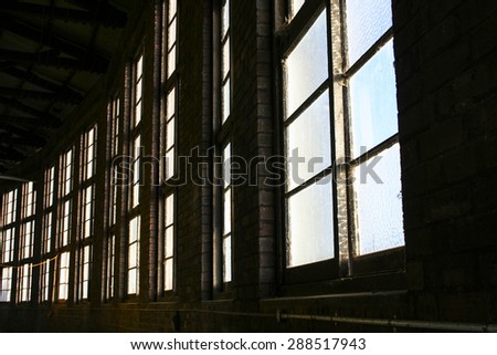 Windows in historic train round house building.