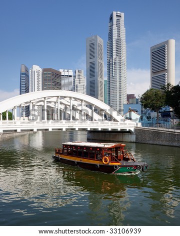 Skyline of Singapore financial district framed by Elgin Bridge and the Singapore River