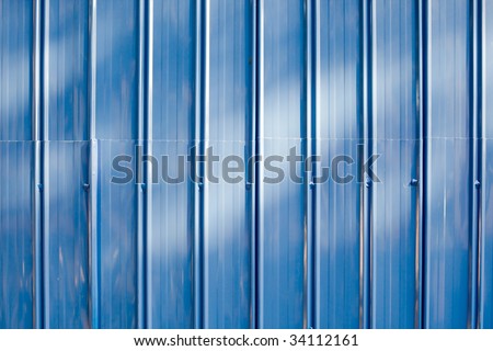 Blue Metal Barrier Background, commonly used at construction sites, lit at sunset