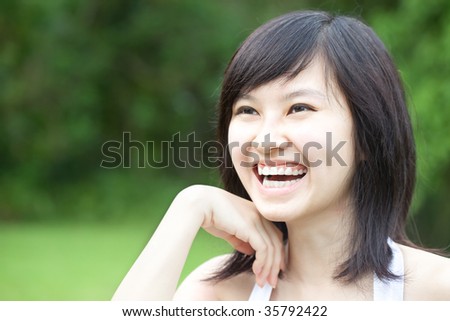 Portrait of a Beautiful Asian Chinese/Japanese girl laughing outdoors