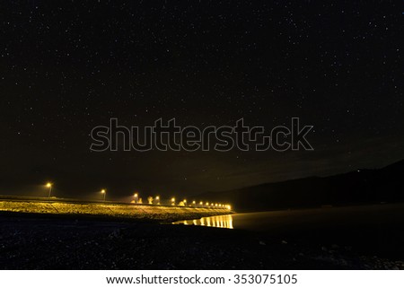 Starry night on the lake, freeway lights