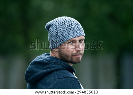 bearded guy with a blue sweatshirt and cap