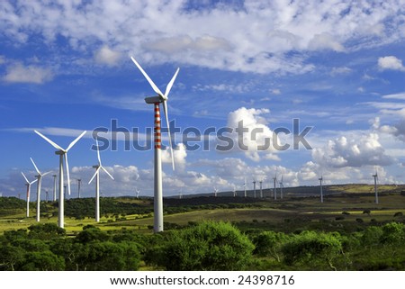 landscape with wind towers and cloudy sky