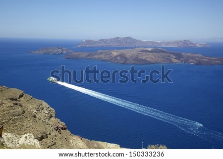 Yachts runing  in ocean with white water track, Santorini, Greece