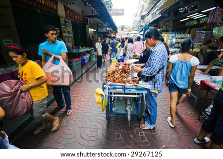 BANGKOK - JULY 29 : Street market sellers busy attend their customers at one of the China town streets July 29, 2007 in Bangkok, Thailand. China town is one of the biggest districts of Bangkok.