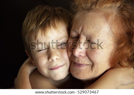Grandmother and grandson hugged and squinted