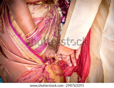 Bride and Groom Hands Together at an Indian Wedding Ceremony