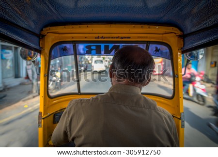View from the inside of an auto-rickshaw in India, \
the Hindu God\'s name \'Sri Veera Kaali\' is written above the windshield.