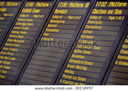 A train departures board and timetable, Liverpool Street railway station, London UK