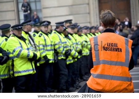 LONDON - APRIL 1 : A volunteer legal observer watches police conduct during G20 protests April 1, 2009 in London. 35,000 people join the demonstrator in Central London.
