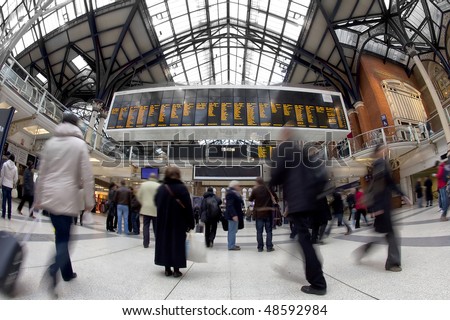 Liverpool street station in the UK at rush hour. Fisheye lens, all faces blurred out and logos/trademarks removed