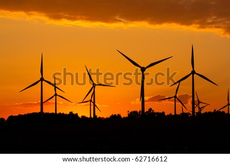 Windmill silhouette on suset background