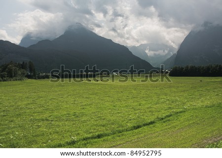Mountains with green grass and clouds