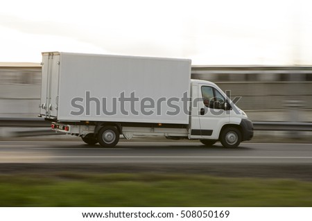 white delivery van on road in motion