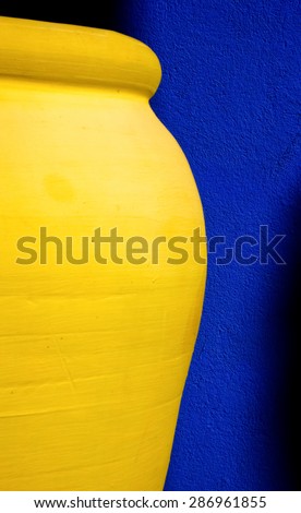 Yellow clay jar on a blue background