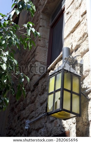 The lantern on the wall.