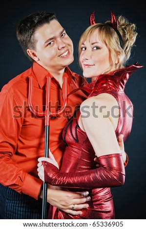 Red devil couple on black background