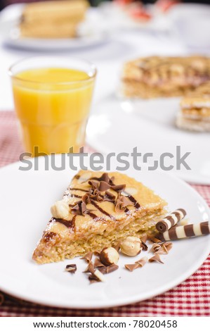 Piece of cake with chocolate and juice on white plate