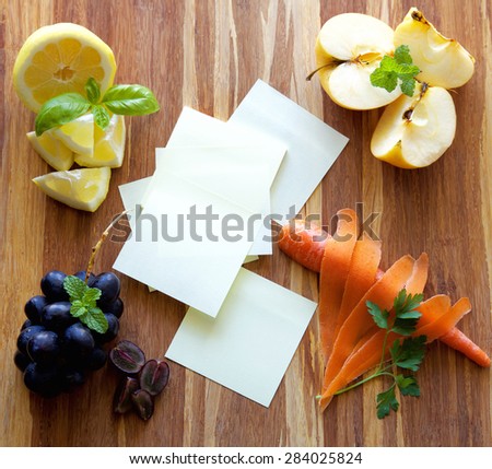 Post it notes with fruits, vegetables and herbs on wood cutting board