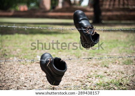 Hanging up boots the barbed wire