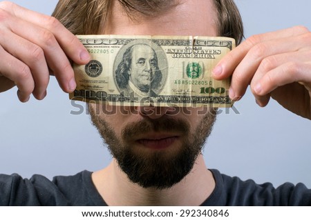 Bearded man closes his eyes dollar