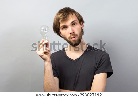 Young man with lightbulb having a good idea
