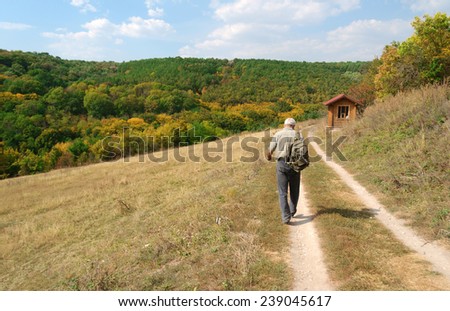 man walking mountain path