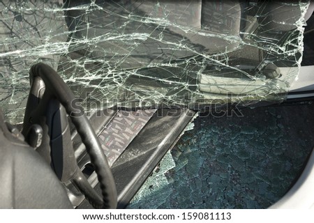 Crashed car on side with broken windows close-up