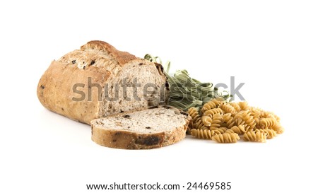 Close up of sliced olive bread and pasta.