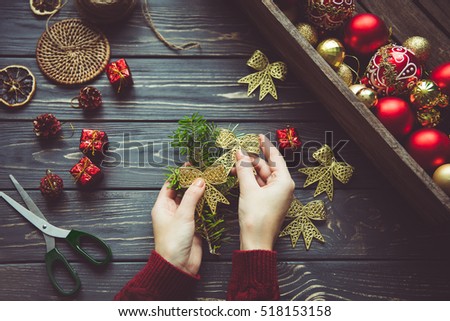 Preparing for Christmas.Vintage holiday decor in female hands on a wooden table.