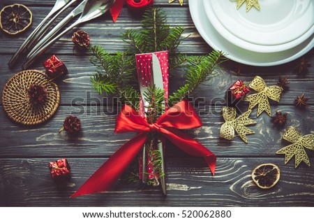 Beautiful Christmas table place setting. Idea for festive table ware decoration. Preparing for Christmas concept.