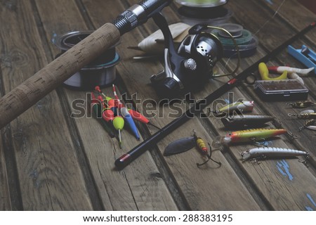 Fishing tackle - fishing rod, fishing line, hooks and lures on wooden  background - Stock Image - Everypixel