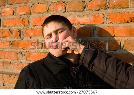 Young man receiving a punch in face(jest)
