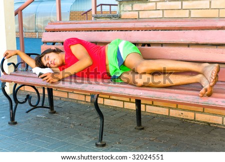 The guy lying on a bench