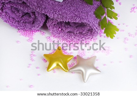 well being concept with towel, pearl bath salt,  bath-oil capsules and plants on white background