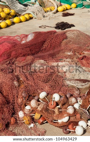 Fishing nets and all sorts of equipment scattered on a pier
