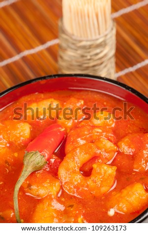 Bowl with a red hot Asian shrimp stew