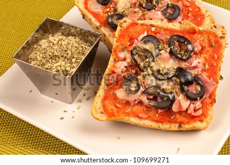 Freshly baked pizza bread with olives and oregano, a tempting treat