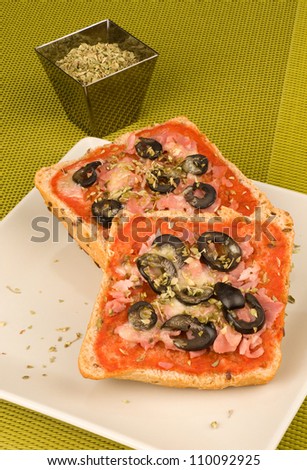 Freshly baked pizza bread with olives and oregano, a tempting treat