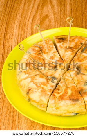 Portion of freshly made Spanish tortilla on a bar counter