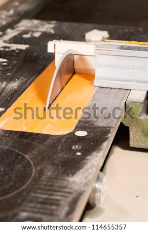 Circular table saw in action in a carpenter workshop